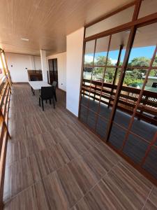 a large room with a table and glass doors at Casa playera in Crucita