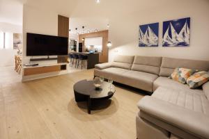 a living room with a couch and a tv and a table at Villa Marcello in Zadar