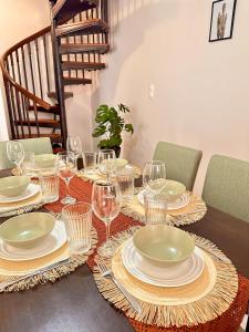 a table with plates and wine glasses on it at Apollonian House in Korinthos