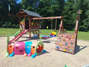 a playground in the sand with a play equipment at Apartamenty W Zaciszu in Kamienica Królewska