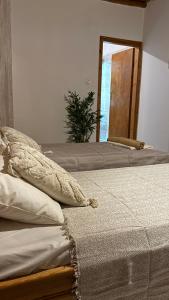 two beds sitting next to each other in a room at Harama Living Finikas in Livanianá