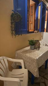 a dining room table with a white table and chairs at Harama Living Finikas in Livanianá