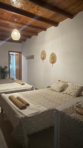 a bedroom with two beds and a chandelier at Harama Living Finikas in Livanianá
