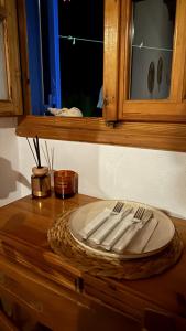 a wooden table with a plate and utensils on it at Harama Living Finikas in Livanianá