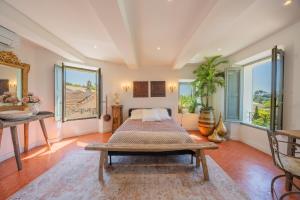 a bedroom with a bed and a table and windows at Maison Aimé in La Motte +18 photos