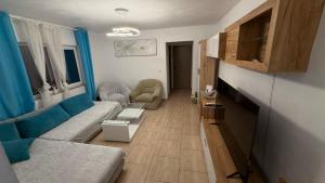 a living room with a couch and a table at Modern Apartment in Arad