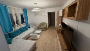 a living room with a couch and a table at Modern Apartment in Arad