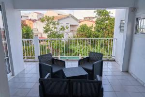a balcony with chairs and a table on a balcony at Logement au vauclin in Le Vauclin