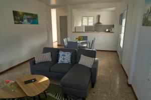 a living room with a couch and a table at Logement au vauclin in Le Vauclin