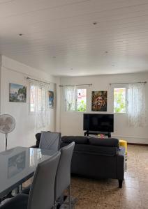 a living room with a couch and a table at Logement au vauclin in Le Vauclin