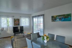 a living room with a table and a couch at Logement au vauclin in Le Vauclin +1 photo