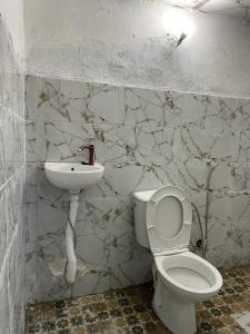 a bathroom with a toilet and a sink at Ryad Cherkaoui in Fez