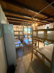 a room with several bunk beds and a table at Arandú Hostel in Itacaré