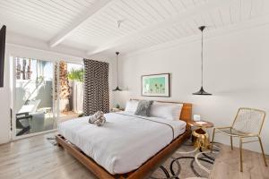 a bedroom with a large bed and a chair at The Weekend by AvantSay in Palm Springs +89 photos