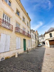 a cobblestone street in a city with buildings at Le cocon de Saumur in Saumur