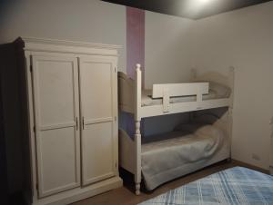 a white bunk bed in a room with a cabinet at Casa TERESINA in Ardenno