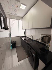 a small kitchen with a sink and a stove at Apartamento Completo e confortável em Sinop Mt in Sinop +7 photos