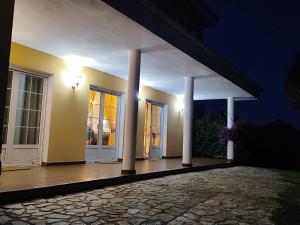 a house with two columns and a porch at night at VV Las Picarolas in Muros de Nalón