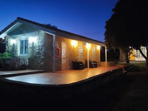 a house with a deck at night with lights at VV Las Picarolas in Muros de Nalón