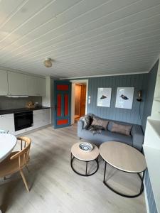 a living room with a couch and a table at Dalhus Valley Apartment in Norddal