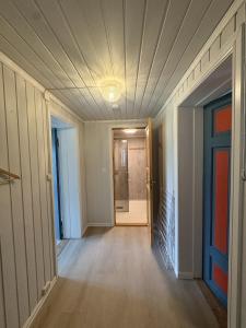 an empty hallway with a door and a room at Dalhus Valley Apartment in Norddal