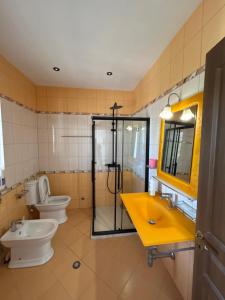 a bathroom with two toilets and a shower and a sink at VillaSolmare Velipoje in Velipojë +15 photos