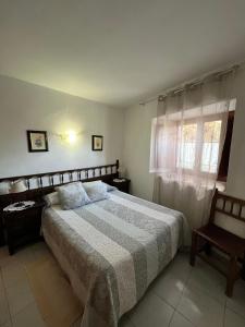 a bedroom with a large bed and a window at Casa Campaner in Valencia de Aneu