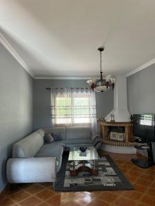 a living room with a couch and a tv at VillaSolmare Velipoje in Velipojë