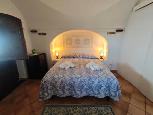 a bedroom with a bed with two towels on it at DAMMUSI IL CARRUBO in Pantelleria +65 photos