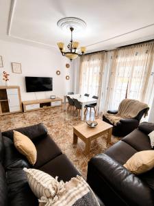 a living room with a couch and a table at Apartamento EL LUCENTINO in Lucena