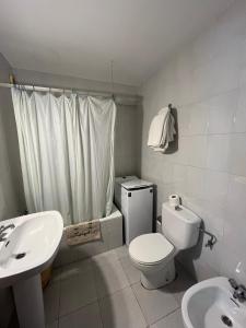 a white bathroom with a toilet and a sink at Casa Campaner in Valencia de Aneu +46 photos