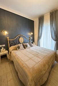 a bedroom with a large bed with a clock on the wall at B&B Giulia in Taormina