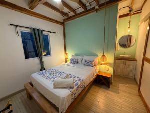 a small bedroom with a bed and a mirror at Hotel Stay Mar Baru in Cartagena de Indias +14 photos