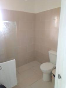 a bathroom with a toilet and a sink at Macao Sky pool Suite in Punta Cana +12 photos