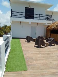 a patio with black chairs and a white building at Macao Sky pool Suite in Punta Cana