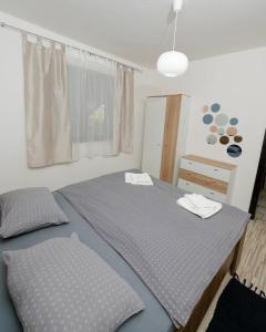 a bedroom with a bed with two towels on it at Kuća za odmor Na jezeru, Šoderica - Fenced Yard & Pet friendly holidayhouse in Legrad