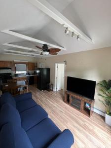 a living room with a blue couch and a flat screen tv at Heavenly Properties SLM in Scituate