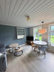 a living room with a table and a couch at Dalhus Valley Apartment in Norddal