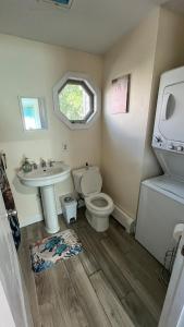 a bathroom with a toilet and a sink at Heavenly Properties SLM in Scituate +13 photos