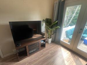 a living room with a large flat screen tv at Heavenly Properties SLM in Scituate
