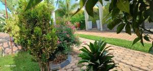 a garden with flowers and plants on a path at Lavender Garden Kabarondo in Kayonza