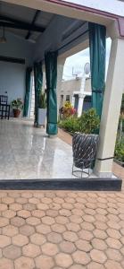 a chair sitting on a patio in a building at Lavender Garden Kabarondo in Kayonza