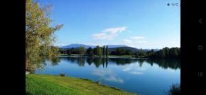 a large lake with trees and mountains in the background at Betty in Saint-Gaudens