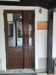 a large wooden door in a building at Apartman Glorija in Brzeće