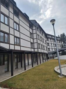 a building with a street light in front of it at Apartman Glorija in Brzeće