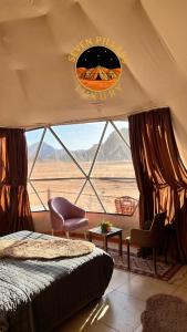 a bedroom with a bed and a view of the desert at SEVEN PILLARS lUXURY CAMP in Wadi Rum +112 photos