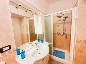 a bathroom with a white sink and a shower at PELAGOS - Agenzia Immobilevante in Ponza +81 photos