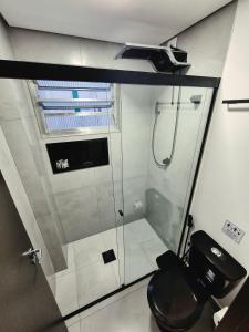 a bathroom with a glass shower with a toilet at Ceci House - Santa Cecília in São Paulo +291 photos