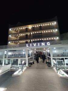 a lit up building with a lit up sign on it at Hotel Living in Casoria