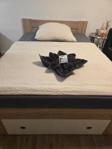 a bed with a black hat on top of it at Bonn Lounge in Bonn